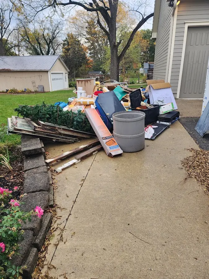 Dumpster being loaded with debris for Roofing Dumpster Rental in Guttenberg